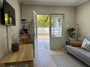 a living room with a couch and a table at The Blossom Room in Robertson
