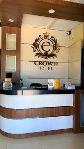 a sign for a crown hotel on a wall at Crown Hotel Pangandaran Syariah in Pangandaran +24 photos