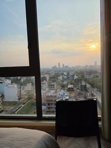 a bedroom with a bed and a view of a city at The Luxury Studio in Gurgaon