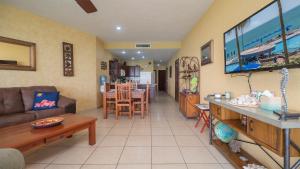 a living room with a couch and a dining room at Sonoran Sun in Campo del Medio