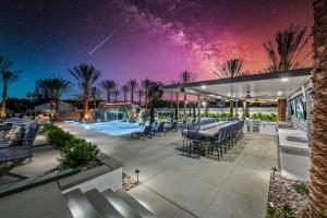 an outdoor patio with a swimming pool at night at Lazy River Oasis in Bermuda Dunes