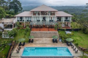 a house with a swimming pool in front of it at Ligness Green Odyssey in Wanduramba