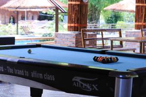 a pool table with a ball on top of it at Woodstock Jungle Camp in Cat Ba