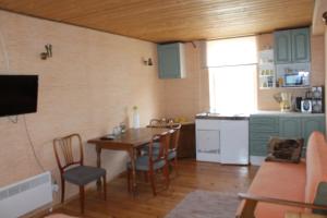 a living room with a table and a kitchen at Aikarali Home Accommodation in Haapsalu