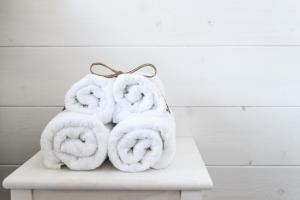 a pile of towels sitting on top of a table at B&B Bucci 54 in Morciano di Romagna