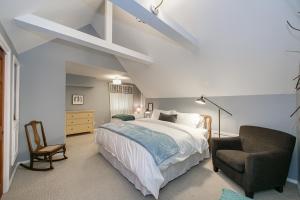 a bedroom with a large bed and a chair at Hyde Park Home in Boise
