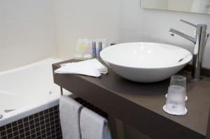 a bathroom with a white bowl sink on a counter at Martin's Brussels EU in Brussels