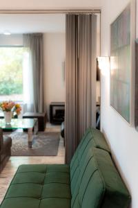 a living room with a green couch in a room at Chez Christine in Vienna +37 photos