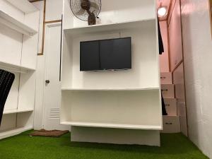a living room with a tv on a wall at Ecostay Panglao Resort Hotel in Panglao Island
