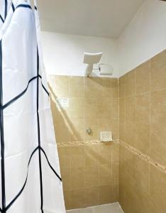 a bathroom with a shower with a shower at Lunas Apartment in Palenque +12 photos
