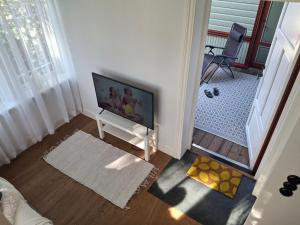 a living room with a flat screen tv on a stand at Villa Manna - Charming Flat in a Historic House in Tallinn