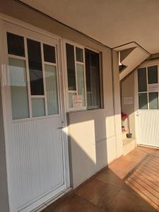 a house with a white door and a porch at Pequeño apartamento Aeropuerto CDMX in Mexico City +2 photos