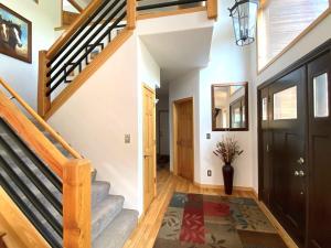 a hallway with a staircase and aoyer with a door at Echo Hills Mountain Lodge - Evergreen Mountain Top Retreat - Foothills of the Rockies in Evergreen +36 photos