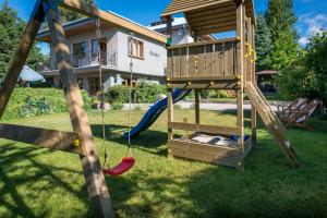 a playground with a tree house and a swing at Farys in Jastrzębia Góra