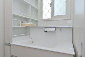 a white kitchen with a sink and a window at Otter Stay - Nagoya Castle in Nagoya +33 photos