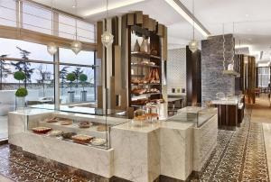 a bakery with a counter with pastries in it at Hyatt Regency Istanbul Atakoy in Istanbul