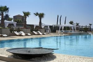 a swimming pool with chairs and a large swimming pool at Hyatt Regency Istanbul Atakoy in Istanbul