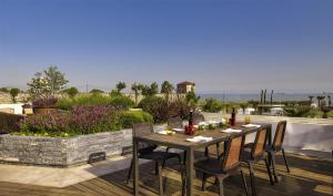 a table and chairs on a patio with a view of the ocean at Hyatt Regency Istanbul Atakoy in Istanbul