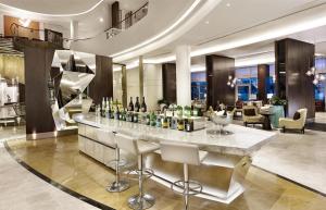 a lobby with a bar with bottles of wine at Hyatt Regency Istanbul Atakoy in Istanbul