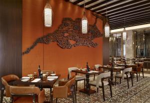 a dining room with tables and chairs and a wall at Hyatt Regency Istanbul Atakoy in Istanbul