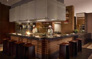 two chefs are preparing food in a kitchen at Hyatt Regency Istanbul Atakoy in Istanbul