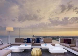 a living room with couches and tables with a view at Hyatt Regency Istanbul Atakoy in Istanbul