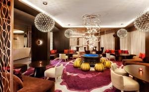 a lobby of a hotel with tables and chairs at Hyatt Regency Istanbul Atakoy in Istanbul