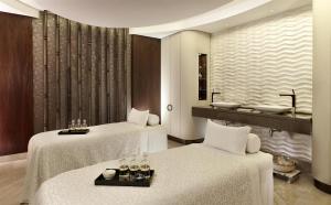 a hotel room with two beds and a sink at Hyatt Regency Istanbul Atakoy in Istanbul