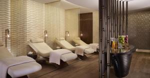 a spa room with a row of white chairs and tables at Hyatt Regency Istanbul Atakoy in Istanbul