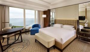 a bedroom with a large bed and a desk and a desk at Hyatt Regency Istanbul Atakoy in Istanbul