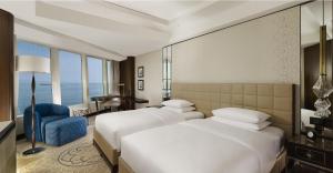 a hotel room with two beds and a desk at Hyatt Regency Istanbul Atakoy in Istanbul +37 photos