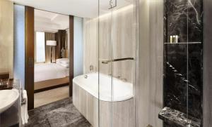 a bathroom with a tub and a sink and a shower at Hyatt Regency Istanbul Atakoy in Istanbul