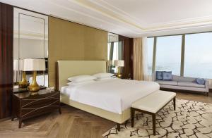 a bedroom with a large white bed and a couch at Hyatt Regency Istanbul Atakoy in Istanbul