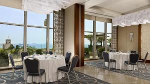 a conference room with tables and chairs and windows at Hyatt Regency Istanbul Atakoy in Istanbul