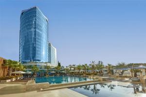 a hotel with a pool and a tall building at Hyatt Regency Istanbul Atakoy in Istanbul