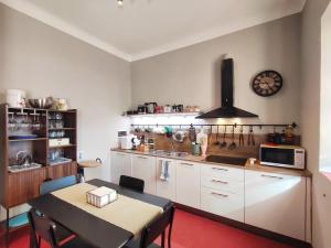 a kitchen with a table and a dining room at Terrazza San Martino San Gimignano Apartments in San Gimignano