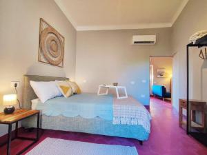 a bedroom with a bed with a chair on it at Terrazza San Martino San Gimignano Apartments in San Gimignano