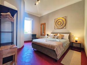 a bedroom with a bed and a large window at Terrazza San Martino San Gimignano Apartments in San Gimignano +5 photos