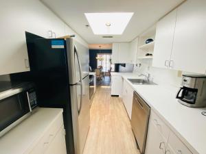 a kitchen with white cabinets and a black refrigerator at Wilmington avenue 50 #316 in Rehoboth Beach