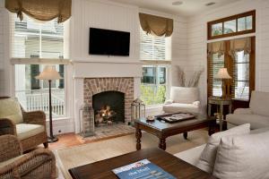 a living room with a fireplace and a tv at 3 Bedroom Wilson Village Home 56 in Bluffton