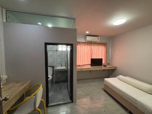 A bed or beds in a room at Lithai Guesthouse