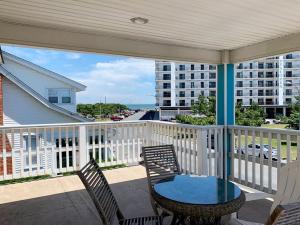 a patio with a table and chairs on a balcony at Lake avenue 21 in Rehoboth Beach