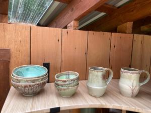 a group of three vases sitting on a shelf at Tree Top Sanctuary Cowichan Valley in Duncan
