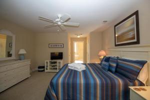 a bedroom with a bed and a ceiling fan at 423 Wahoo Dr in Fripp Island +35 photos