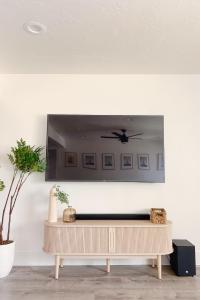 a mirror on a wall above a table in a room at Hale Moana Retreat AC Walk to Ocean and Spacious Family Stay in Laie