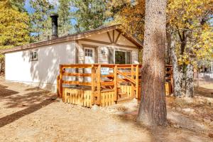 a small cabin with a fence and a tree at Holmes Away From Home #2485 in Sugarloaf