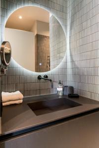 a bathroom with a sink and a mirror at Vondel 99 in Amsterdam
