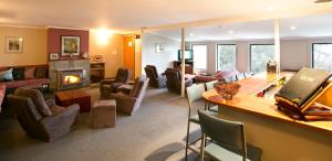 a living room with a couch and a fireplace at Diana Alpine Lodge in Falls Creek