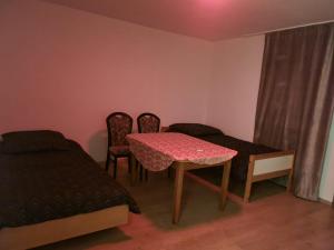 a room with a table and two chairs and a bed at MHm in Passau