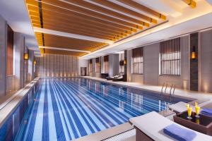 a large swimming pool in a hotel room at Cheery Dragon Canal Hotel Hangzhou - Intangible Cultural Heritage Hotel in Hangzhou